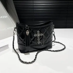 Black quilted leather bucket bag with gothic metal cross and skull chain details