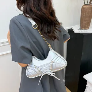 Silver athletic-inspired ballet style crossbody bag with lace-up details and chain strap