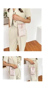 Detail of light pink crossbody phone bag with vintage floral jacquard and button closure