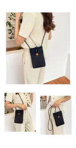 Lifestyle views of a black mini crossbody phone bag with an orange floral charm