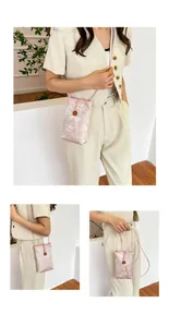 Detail of pink Chinese jacquard phone bag with floral pattern and wooden petal button