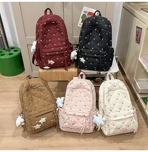 Quilted mini backpacks in five colors featuring bow embroidery and star plush keychains