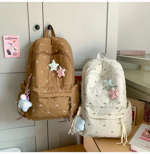 Detailed quilted nylon backpacks with elegant bow embroidery and puffy star charms