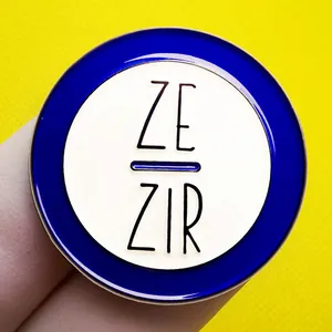 Round Ze/Zir pronouns enamel pin in blue and white on yellow honeycomb background