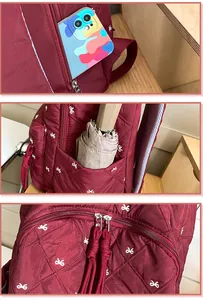 Detail showing side pocket for umbrella and front zip compartment on quilted backpack