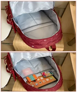 Internal view of a red quilted backpack showing compartments with tablet and accessories