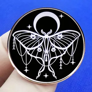 Gothic luna moth and crescent moon enamel pin with celestial stars on black background