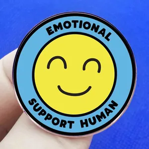 Emotional Support Human enamel pin with yellow smiley face and blue outer circle badge