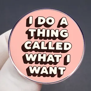 Pink round enamel pin featuring I DO A THING CALLED WHAT I WANT motivational slogan