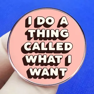 Pink round brooch featuring I DO A THING CALLED WHAT I WANT motivational text design