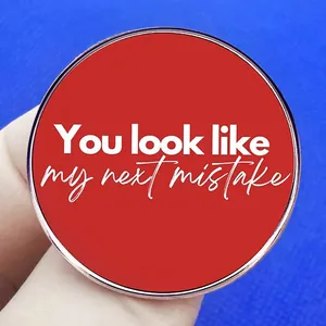 Red circular pin badge with white text You Look Like My Next Mistake for clothing