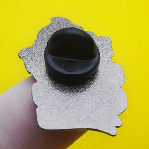 Macro view of the silver enamel pin back with a black rubber clutch and matte metal finish