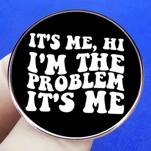 Round black enamel pin with IT'S ME HI I'M THE PROBLEM IT'S ME text and rose gold trim