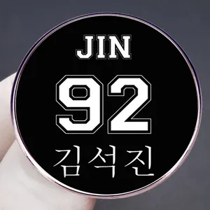 BTS Jin 92 metal pin badge featuring Kim Seok-jin's name on a black enamel surface
