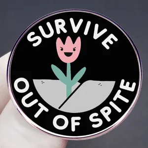 Enamel pin featuring a pink tulip in a crack with 'SURVIVE OUT OF SPITE' text