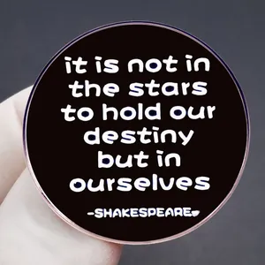 Close-up of Shakespeare quote enamel pin with rose gold edge on a textured background