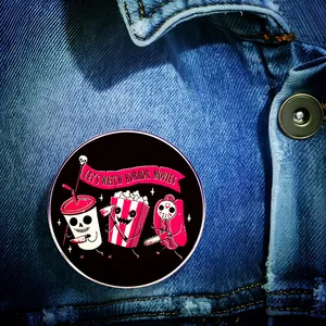 Let's Watch Horror Movies cartoon brooch pinned on blue denim jacket for Halloween