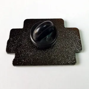 Close-up of the black matte metal badge back featuring a secure rubber pin clutch