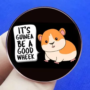 Round guinea pig badge featuring IT'S GUINEA BE A GOOD WHEEK pun on black background