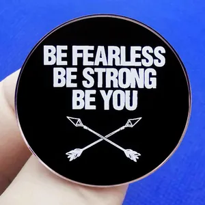 Inspirational round enamel pin with BE FEARLESS BE STRONG BE YOU slogan and arrow motif