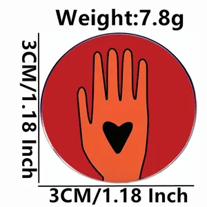 Ceasefire enamel pin badge featuring orange hand and black heart, 3cm diameter size