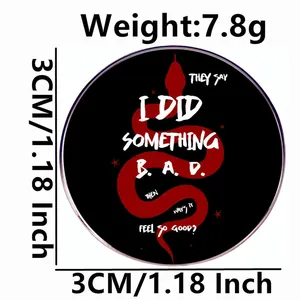 3cm round black enamel pin featuring a red snake design and artistic lyric font