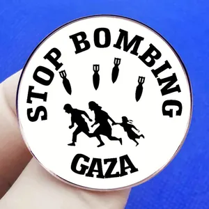 Stop Bombing Gaza round metal brooch pin featuring political silhouette design