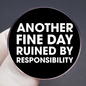 Round black enamel pin with Another Fine Day Ruined by Responsibility slogan text