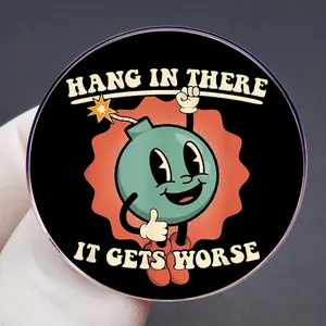Round pin badge with retro cartoon bomb and Hang in There It Gets Worse text