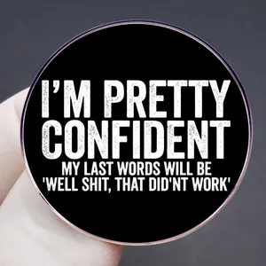 Funny black round enamel pin with white text quote about confident last words for bags