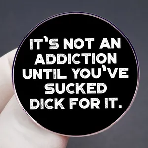 Funny black round pin with humorous white English text 'It's not an addiction' quote