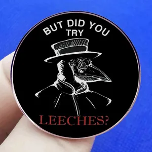 Plague doctor enamel pin with 'But did you try leeches?' text on black metal badge