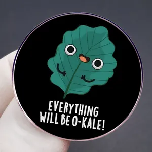 Round Kale leaf brooch with Everything Will Be O-Kale pun on black enamel background