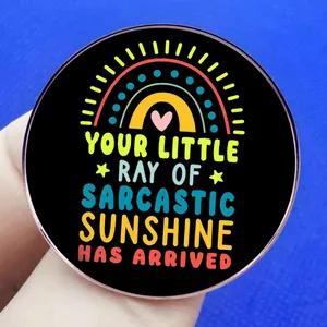 Enamel pin badge with rainbow heart design and sarcastic sunshine text on black background