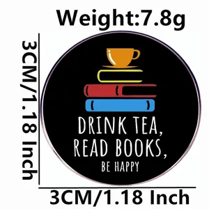 Round enamel pin featuring a tea cup and books with Drink Tea, Read Books, Be Happy slogan