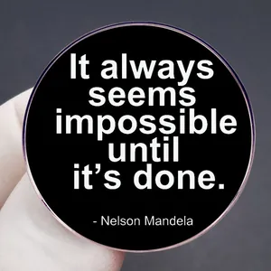 Nelson Mandela quote brooch in matte black with 'It always seems impossible until it's done'