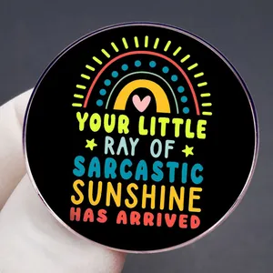 Sarcastic sunshine metal lapel pin with colorful rainbow and heart design in hand