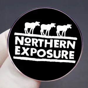 Classic black and white Northern Exposure enamel pin featuring elk silhouettes