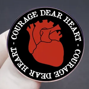 Enamel pin badge featuring red anatomical heart with Courage Dear Heart text
