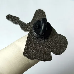 Detail of guitar enamel pin back showing matte black metal finish and rubber clutch