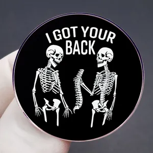 Skeleton brooch with 'I GOT YOUR BACK' text in black and white enamel finish