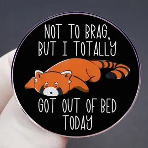 Cartoon red panda enamel pin badge with 'NOT TO BRAG, BUT I TOTALLY GOT OUT OF BED TODAY' text