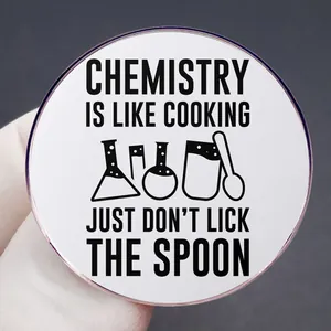 Funny Chemistry is Like Cooking lapel pin with quote and lab equipment held by hand