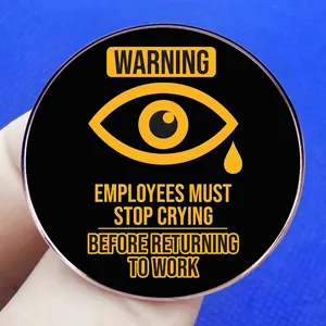 Round black enamel brooch pin featuring funny work-life warning text for office employees