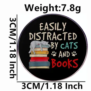 Round enamel pin featuring a cat on books with Easily Distracted by Cats and Books text