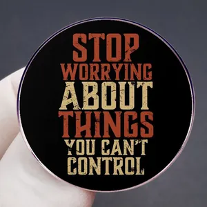 Stop Worrying motivational metal badge pin with retro distressed text on black circle