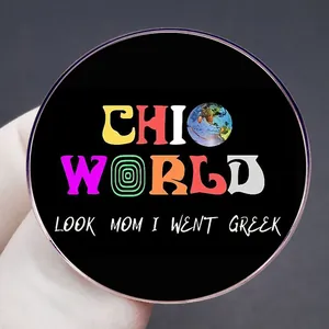 Round Chio World enamel brooch with Look Mom I Went Greek slogan on black metal pin