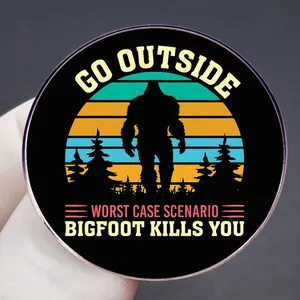 Funny Bigfoot pin with Go Outside text and retro sunset stripes on a round badge