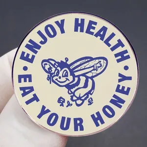 Retro bee enamel pin with Eat Your Honey and Enjoy Health slogans on a beige round badge