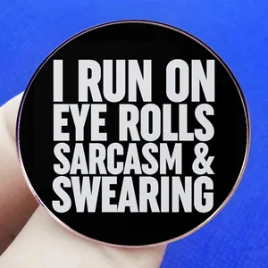 Round sarcastic badge with I RUN ON EYE ROLLS text and rose gold metal frame finish